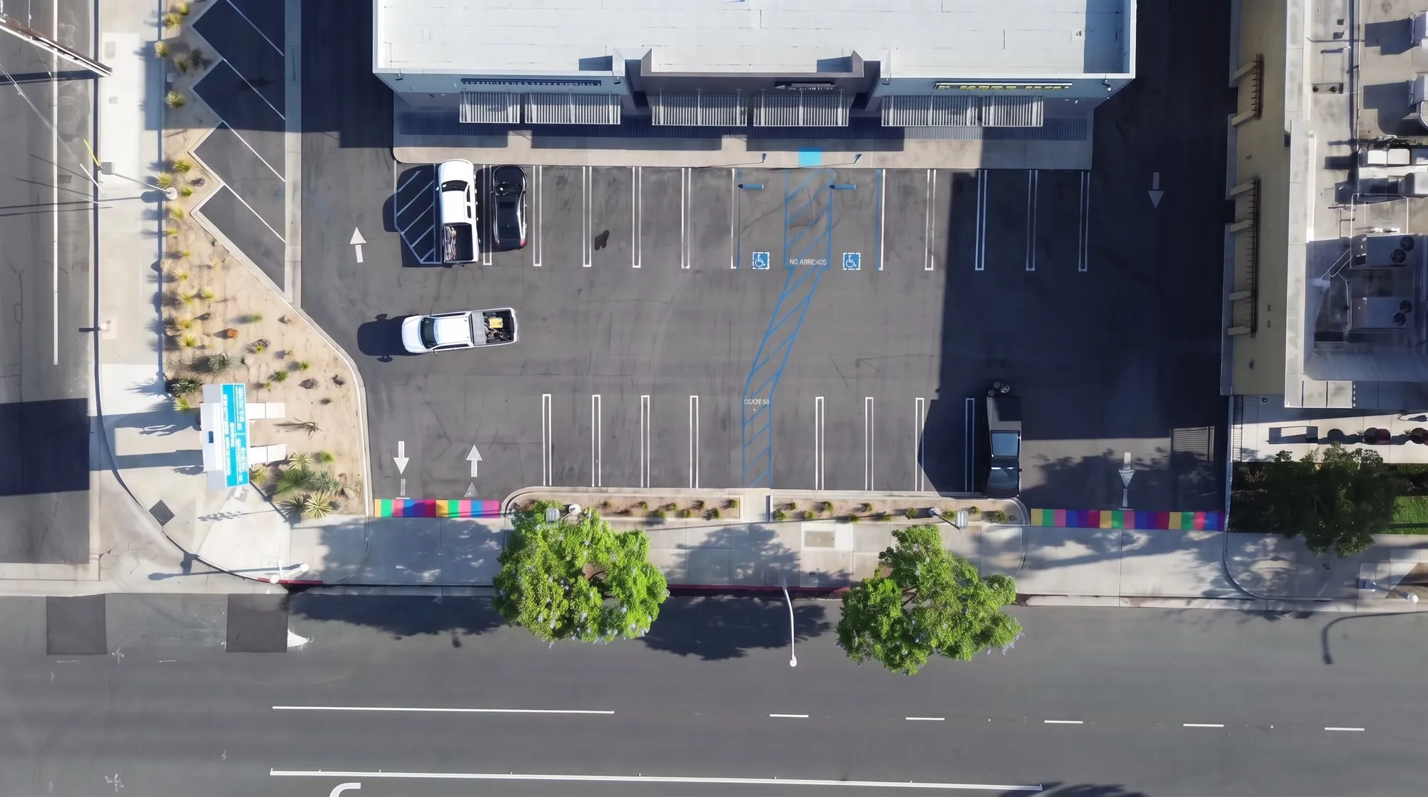 Actual top-down drone view showing the building, parking lot, and Lincoln Avenue